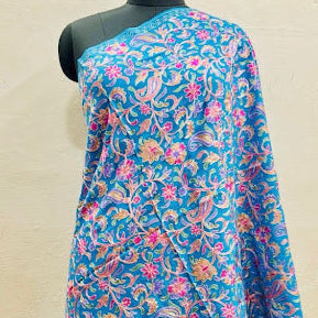 Blue floral patterned fabric on a mannequin against a plain background