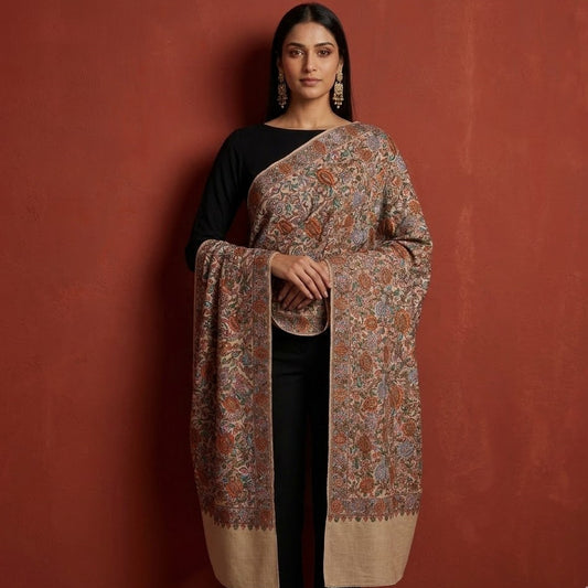 Woman wearing a patterned shawl against a red background