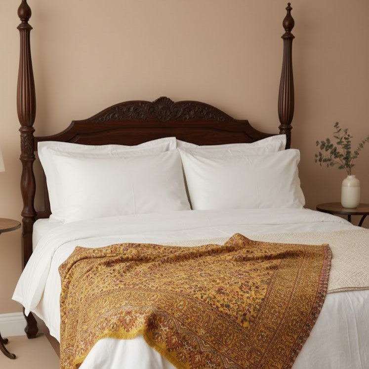 Pure wool kani shawl with sunflower design draped on a bed