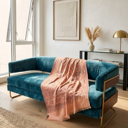 Blue sofa with a pink blanket in a modern living room