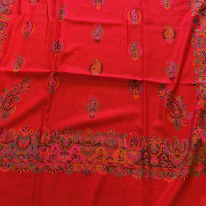 Red fabric with gold patterns on a wooden floor