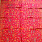 Red patterned fabric on a wooden floor