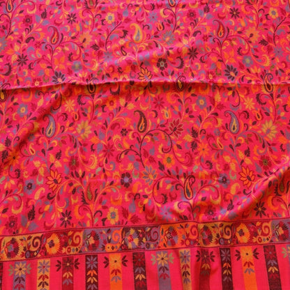 Red patterned fabric on a wooden floor