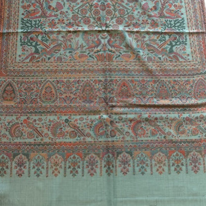 Long piece of fabric with intricate patterns on a white background