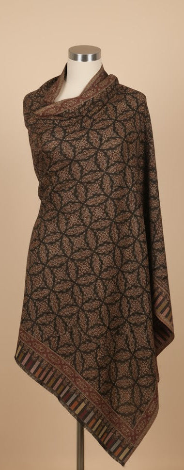 Brown patterned scarf on a mannequin against a beige background
