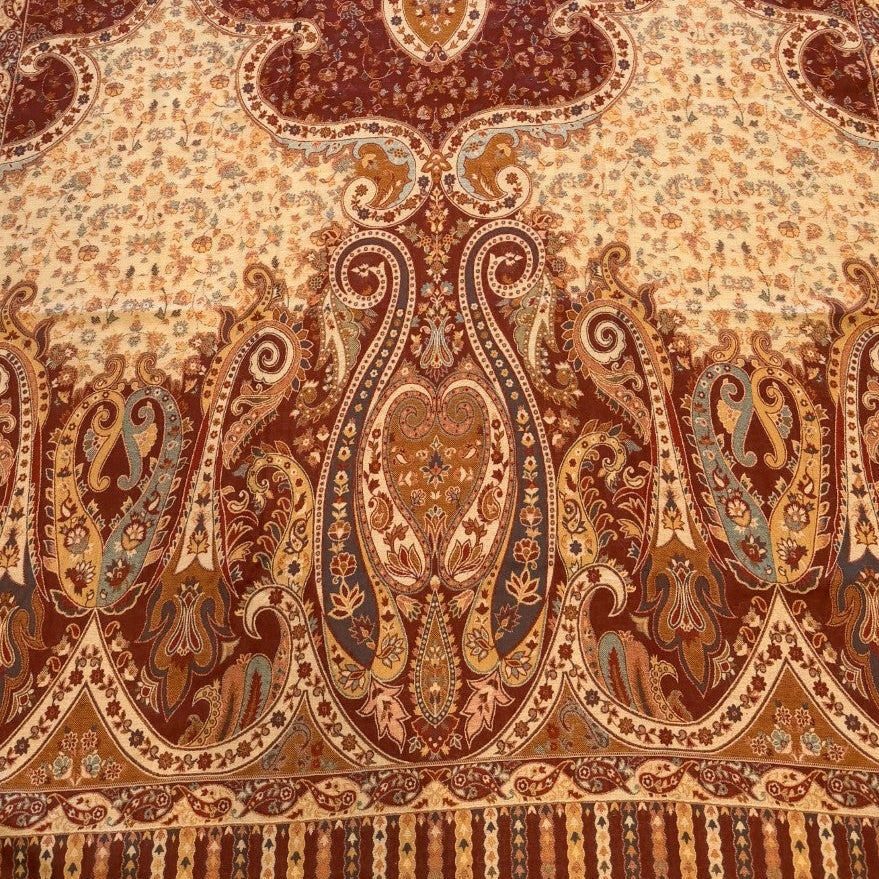 Decorative rug with intricate patterns on a light wooden floor.