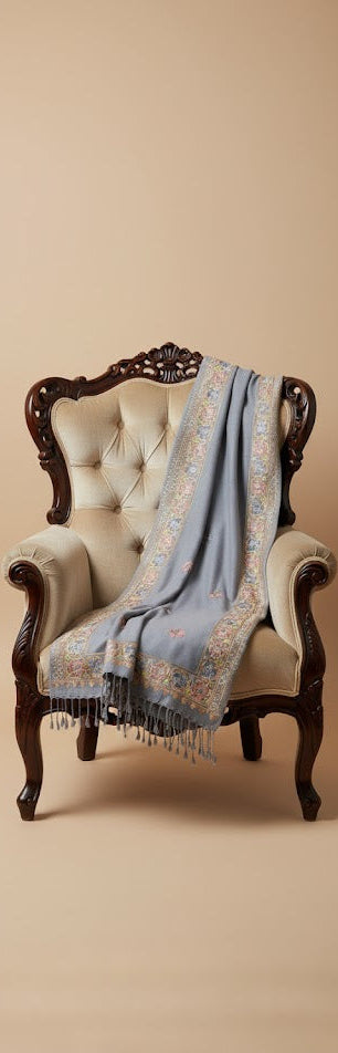 Decorative blue shawl draped over a vintage chair against a beige background