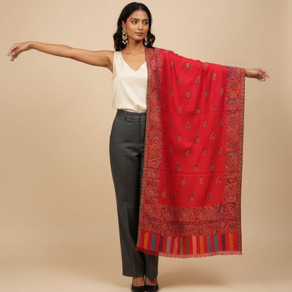 Woman wearing a red patterned scarf on a beige background