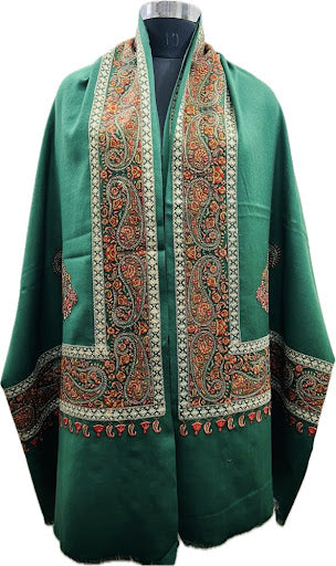 Green embroidered shawl on a mannequin with a white background