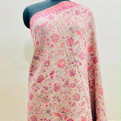 A long-sleeve kurta or tunic displayed on a black mannequin torso, featuring a light pink base with an all-over floral print in red, pink, and purple tones, set against a plain off-white wall.