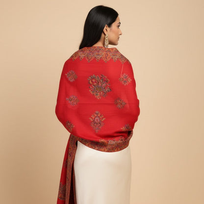 Woman wearing a red embroidered dupatta over a beige background