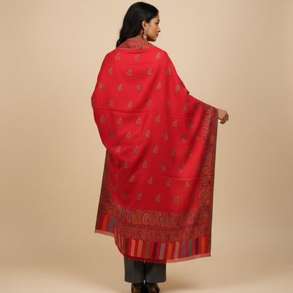 Woman wearing a red patterned shawl on a beige background