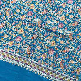 Blue floral patterned fabric on a wooden surface