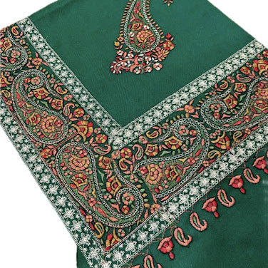 Green fabric with intricate paisley patterns and embroidery on a white background