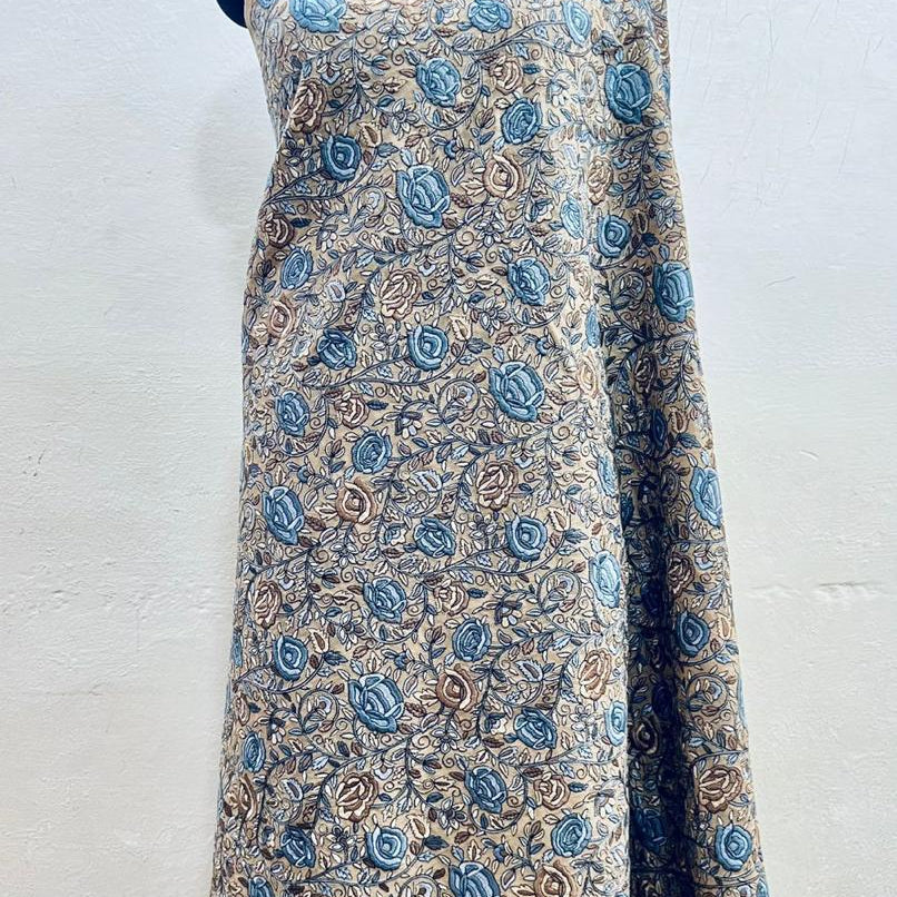 Floral patterned fabric draped over a mannequin on a white background