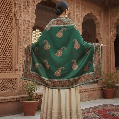 Woman wearing a green embroidered shawl in an ornate architectural setting