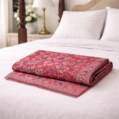 Kani Shawl in maroon on a bed