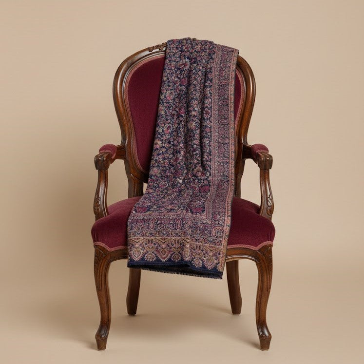 Kani shawl in navy blue draped on a chair