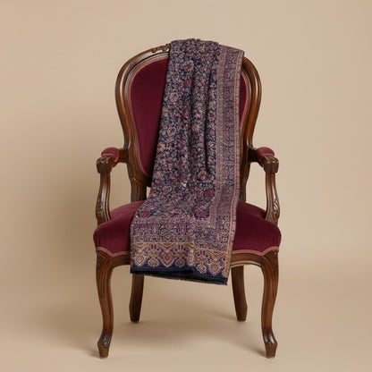 Kani shawl in navy blue draped on a chair