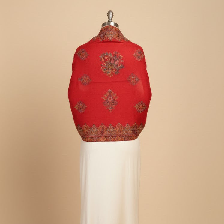 Red embroidered garment on a mannequin against a beige background