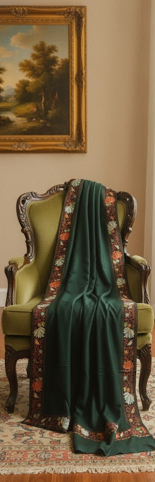 Green dress with floral patterned shawl draped over a chair in a room with a painting on the wall.