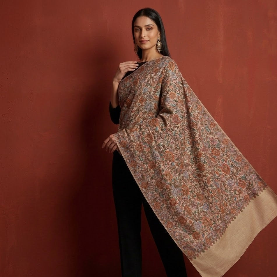 Woman wearing a patterned shawl against a red background