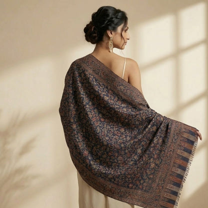 Woman wearing a patterned shawl in a softly lit room