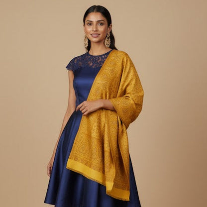 Woman wearing a blue dress with a yellow shawl on a beige background