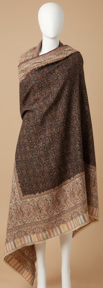 Brown patterned shawl on a mannequin against a beige background