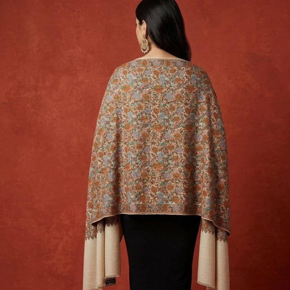 Woman wearing a floral patterned shawl against a red background
