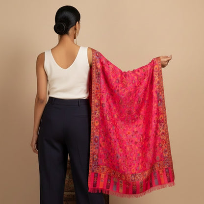 Woman holding a red patterned scarf against a beige background