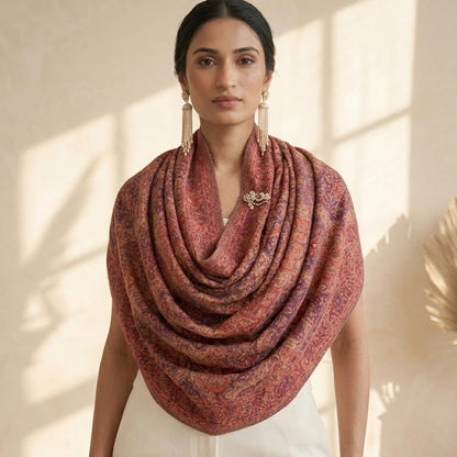 Woman wearing a large red scarf in a bright room