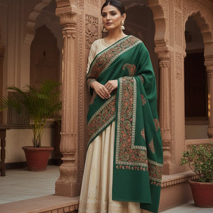 Woman in a green and white traditional outfit standing in an ornate architectural setting.
