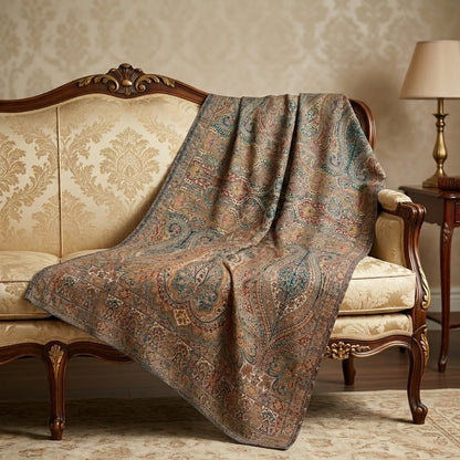 Patterned shawl  draped over a decorative sofa in a room with a lamp and side table.