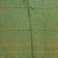 Green patterned fabric on a wooden floor