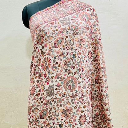 Floral patterned floral pure wool shawl in kani design draped over a mannequin on a plain background