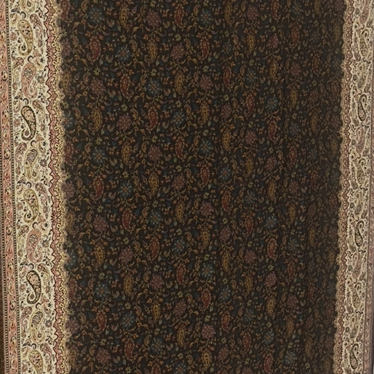 Decorative shawl with intricate patterns on a plain background