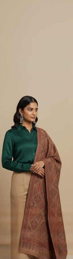Woman wearing a green shirt and brown patterned shawl on a beige background