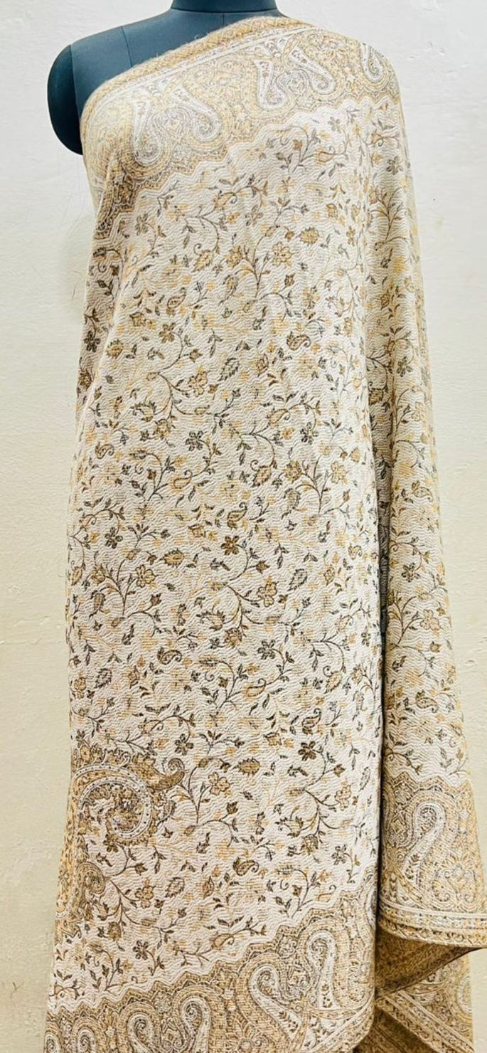 Beige floral patterned shawl draped over a mannequin against a white background