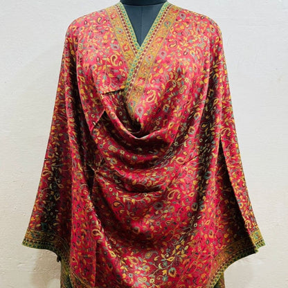 Red patterned scarf draped over a mannequin against a white background
