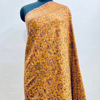 Pure wool kani shawl with sunflower design draped on a female model