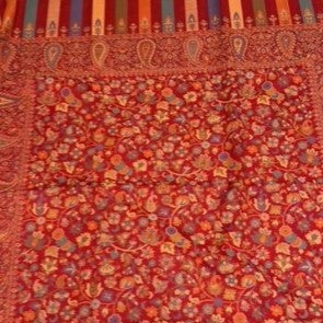 Red fabric with intricate patterns and colors