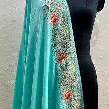 Turquoise dupatta with floral embroidery on a mannequin against a plain background