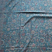 Decorative blue patterned rug on a wooden floor