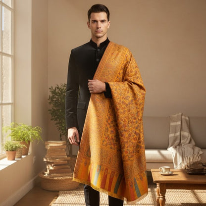 Man wearing a traditional orange shawl in a living room setting