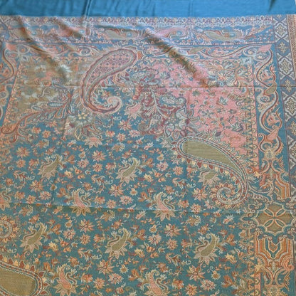 Decorative deep teal blue patterned jamawar kani pure wool shawl with intricate patterns on a wooden floor.