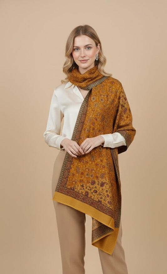 Woman wearing a patterned orange scarf on a beige background