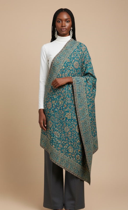 Woman wearing a blue patterned shawl on a beige background