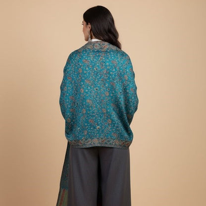 Model wearing azure blue faux Pashmina stole on a beige background