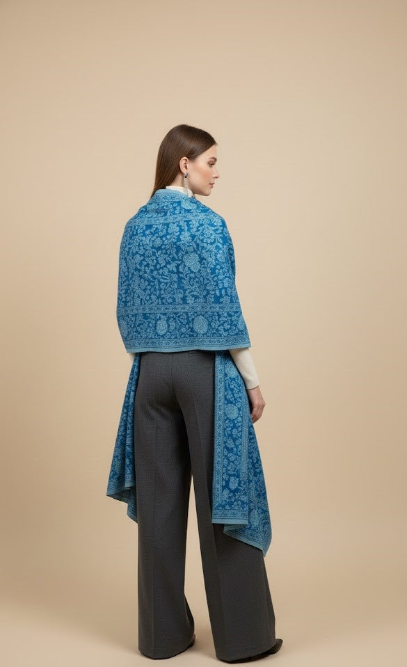 Woman wearing a blue lace shawl over a beige background